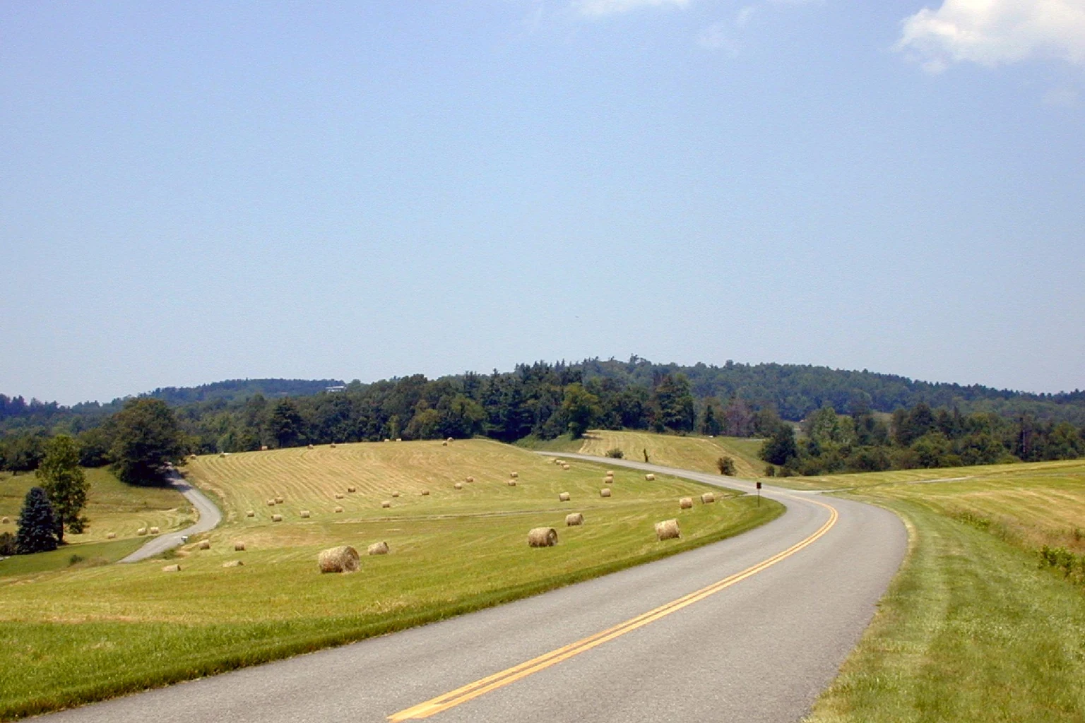 Blue Ridge countryside in Virginia with hay fields and a winding road