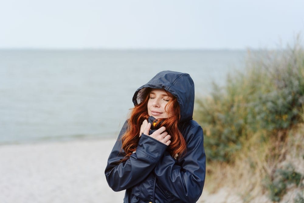 A woman snuggling into her warm anorak