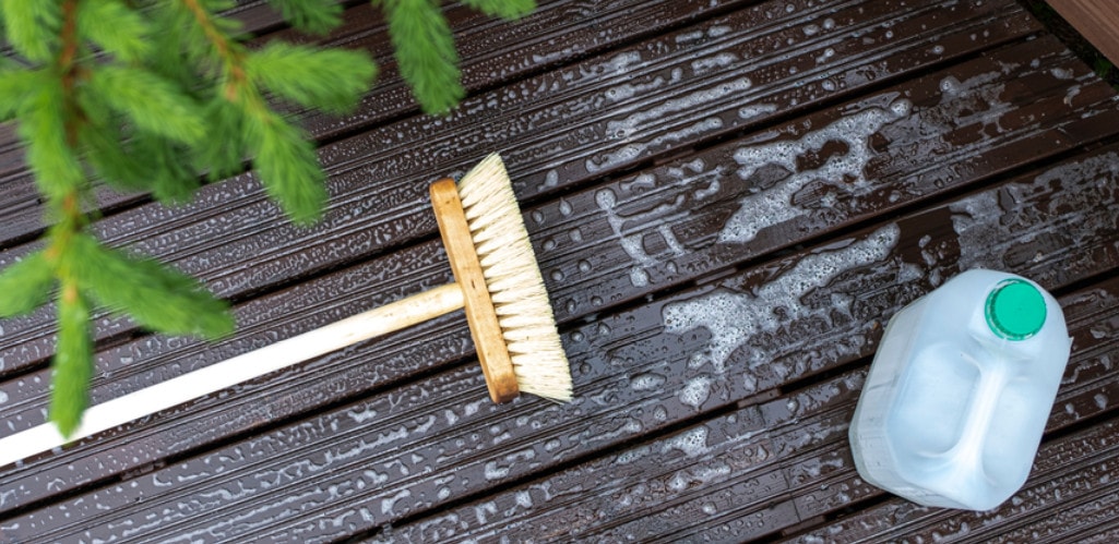 Lying brush and a detergent on a wood floor