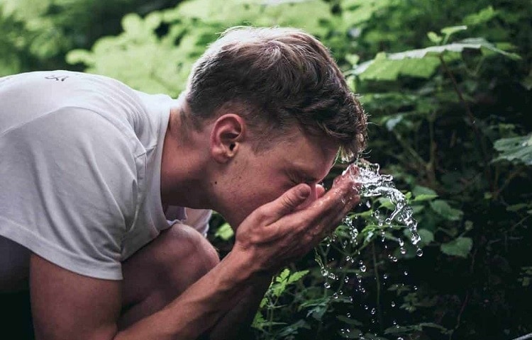 a man washing his face 