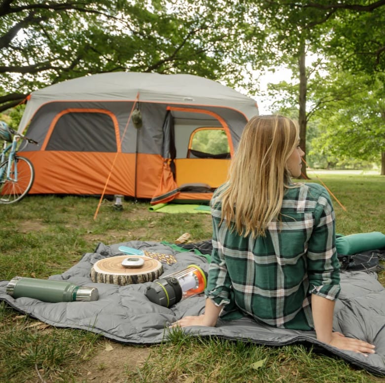 Woman camping with her cabin tent