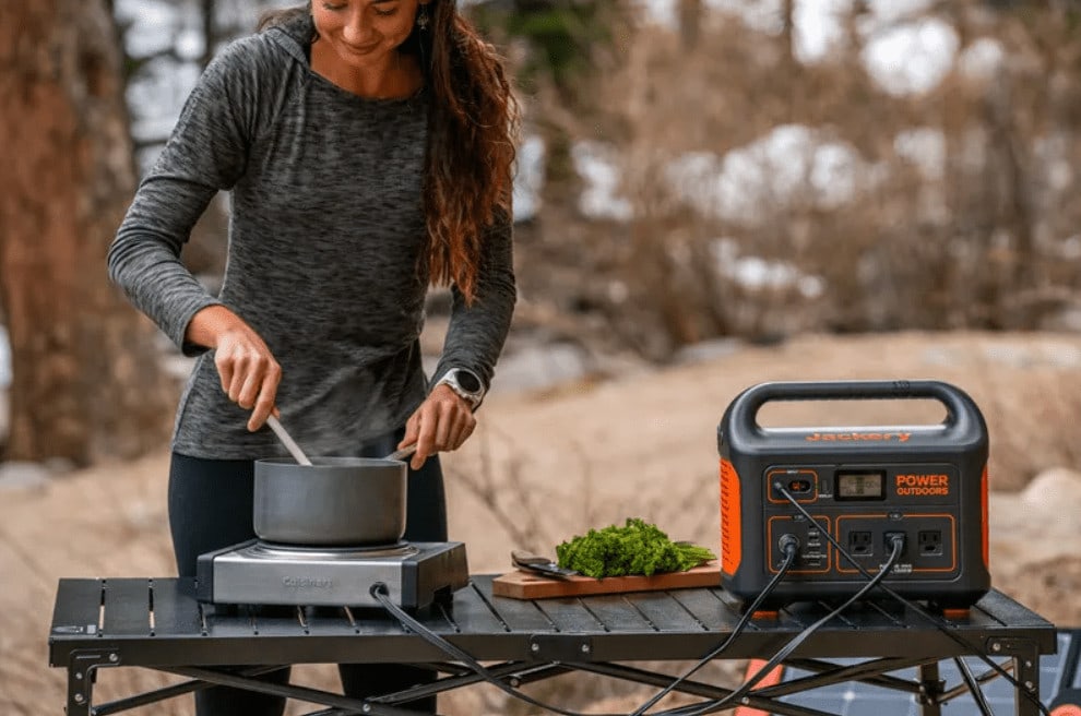 Lady cooking while using generation during camping