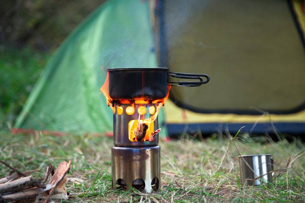 Camping Wood Stove with fire on the grass