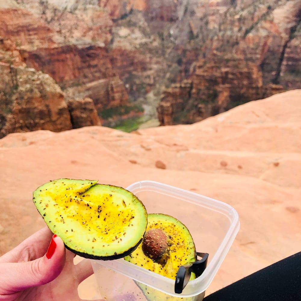 Hiker bringing an avocado snack during a hike