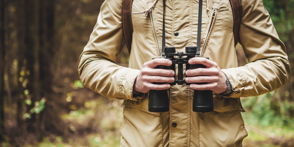 Man holding a camera during hiking