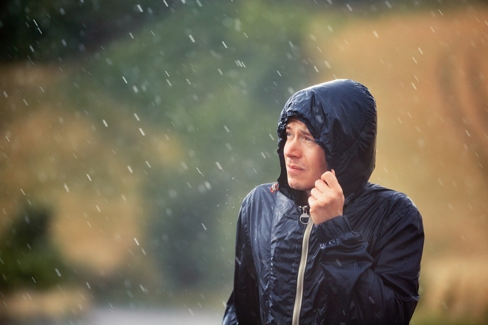 Man wearing a rain coat during a rain