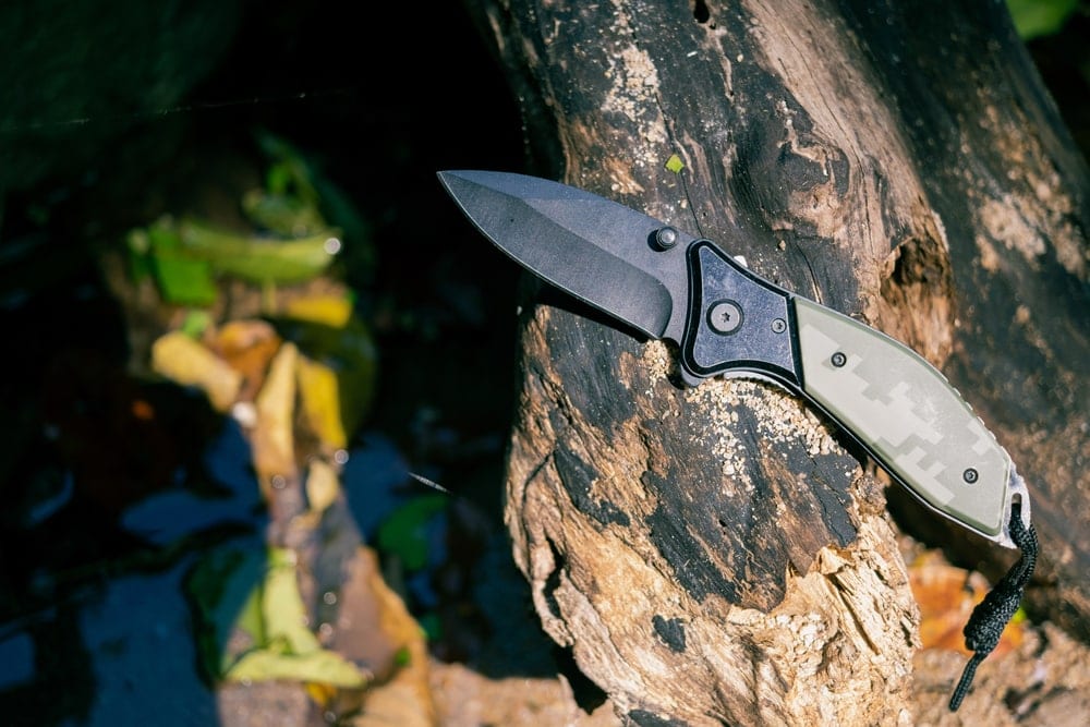 Camo hunting knife on a tree branch