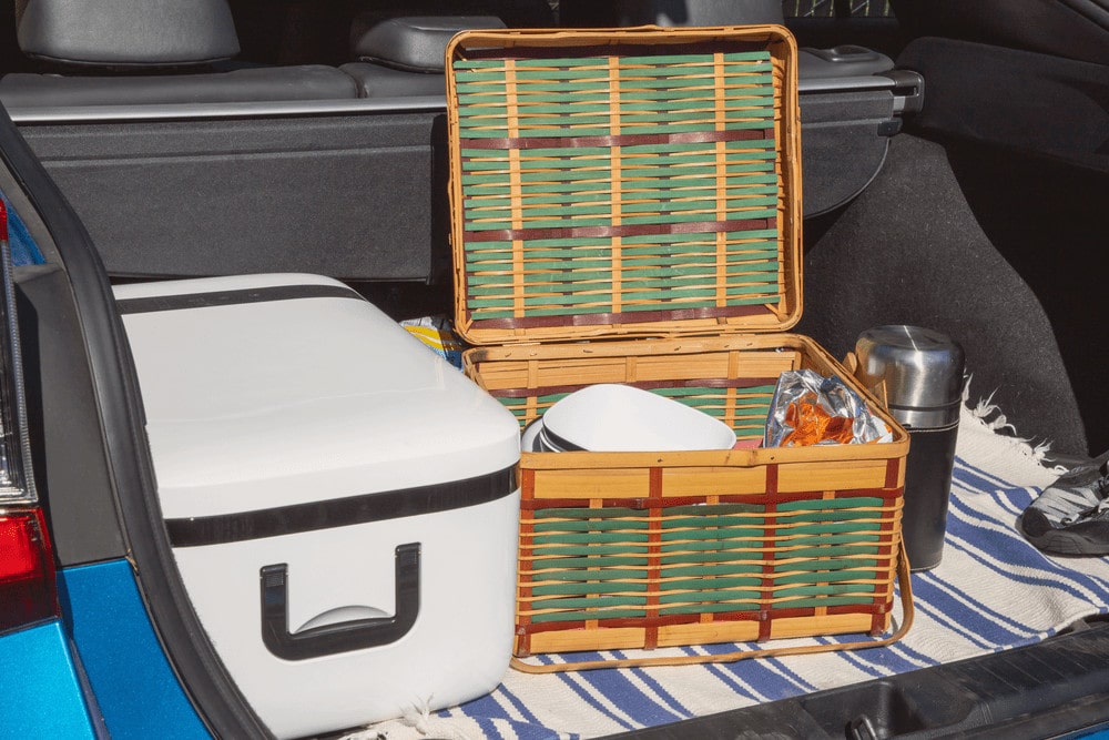Camping plates and food inside storage and cooler