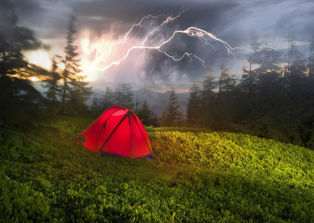 Camping tent in a thunderstorm on top of the hill
