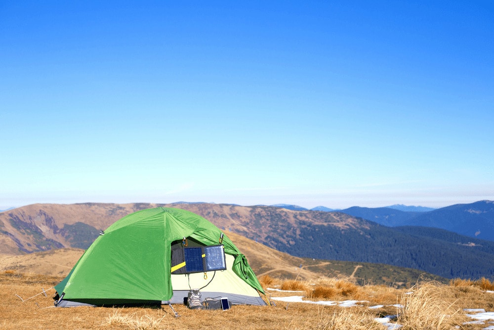 Camping without electricity on a mountain top with hanging solar panels