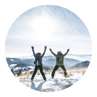 Two people hiking in joy during winter