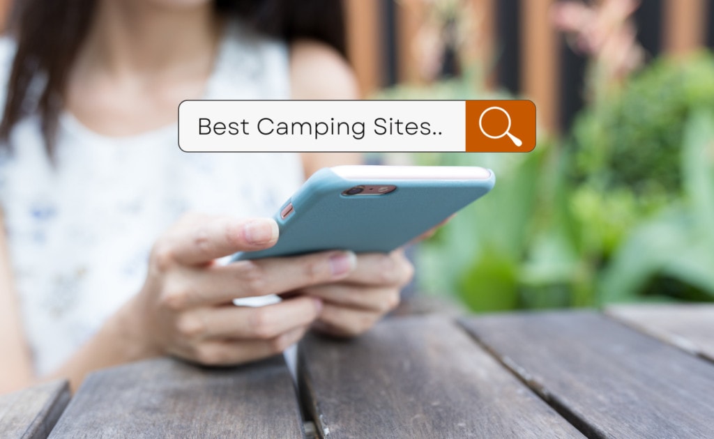 woman searching on phone for best camping sites