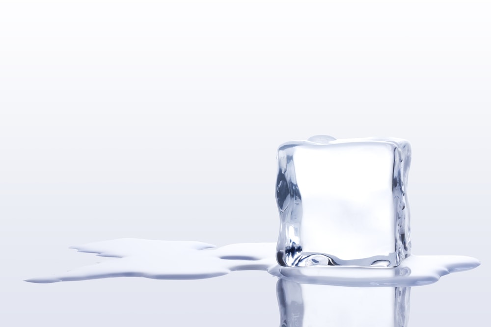 Close up photo of melting ice on white background