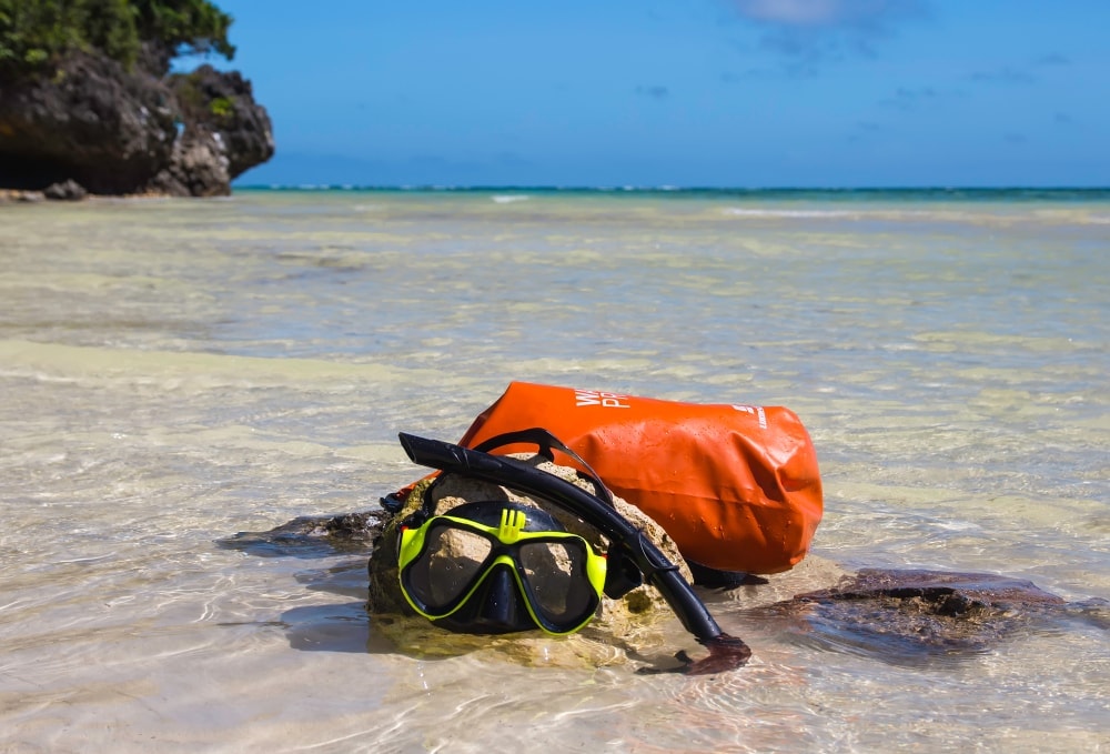 Backpack and snorkeling equipment on water