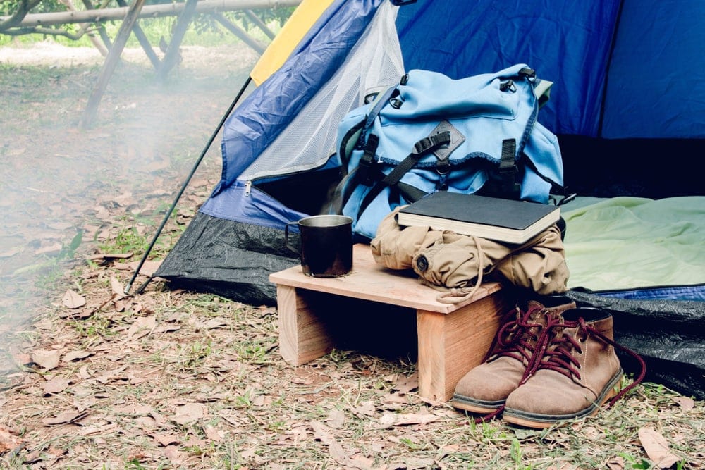 Shoes and bags outside a tent
