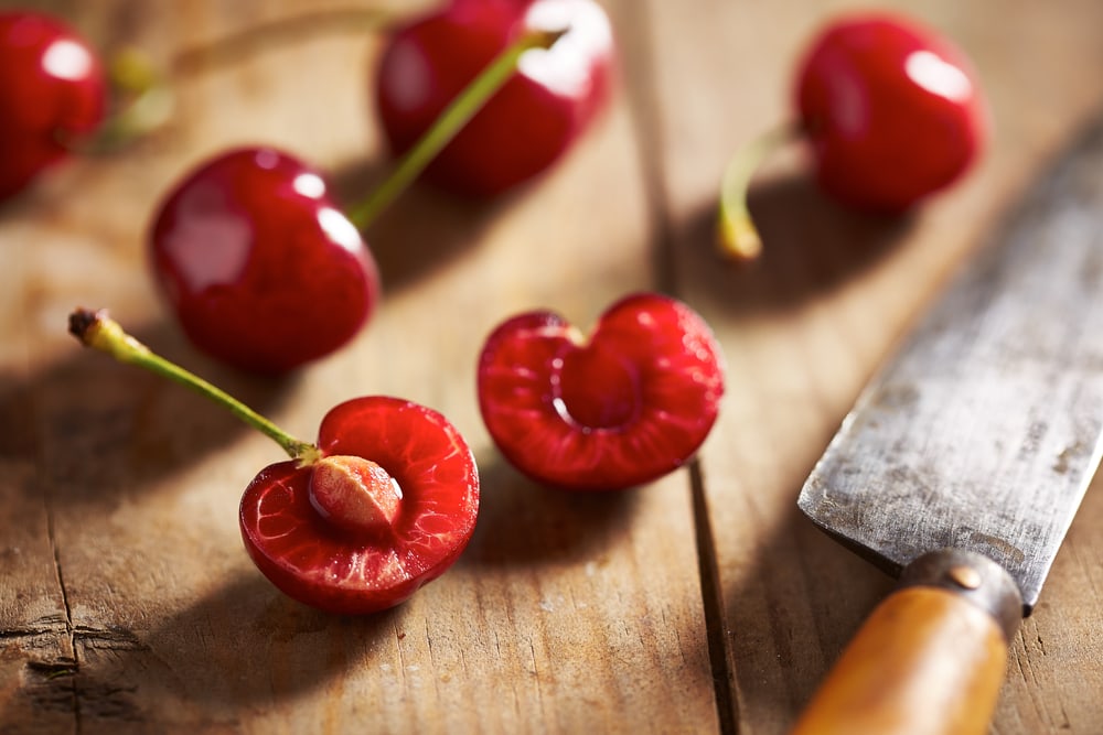 Red cherry cut open to see its seed