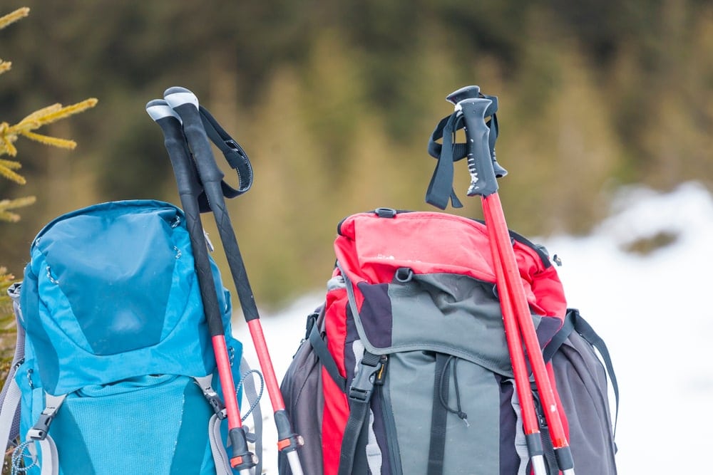 Two pair of hiking sticks on two backpacks