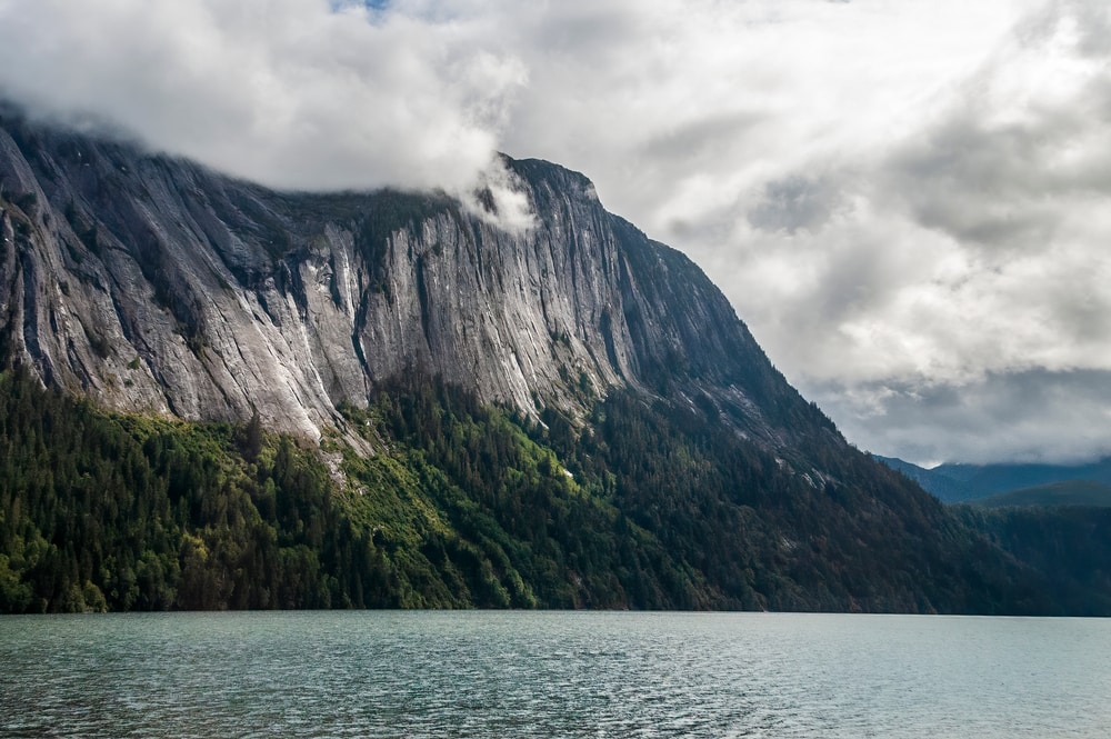 Misty Fjords national monument completely covered by clouds during an overcast weather