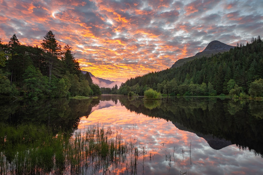 Sunrise at Glencoe Pap mountain and the Lochan, Highlands, Scotland during a cloudy weather
