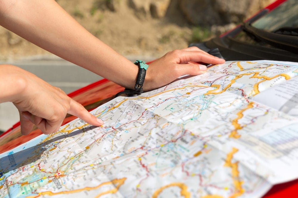 Image of a person pointing at a road map