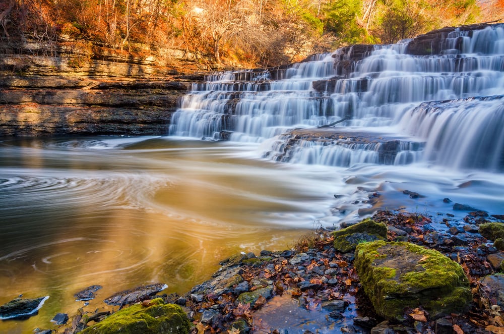 Silky water cascades over limestone rock at Burgess Falls State Park in Tennessee