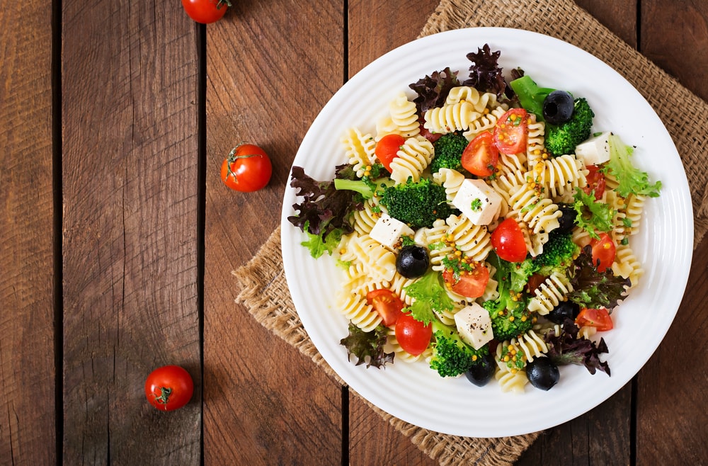 Pasta salad with tomato, broccoli, black olives, and cheese feta
