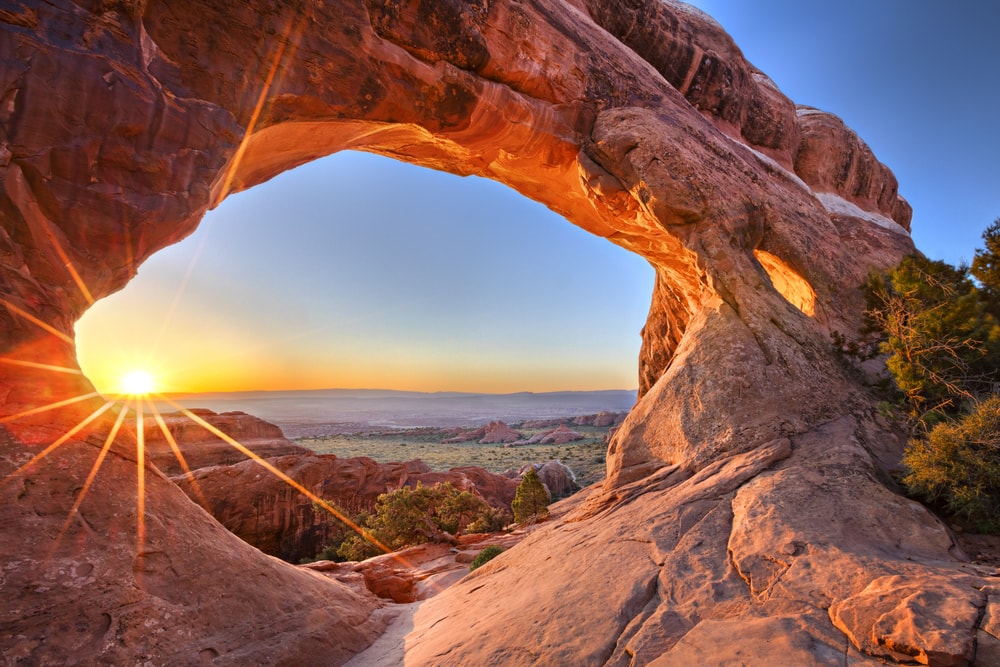 sunrise at Partition Arch in Arches National Park