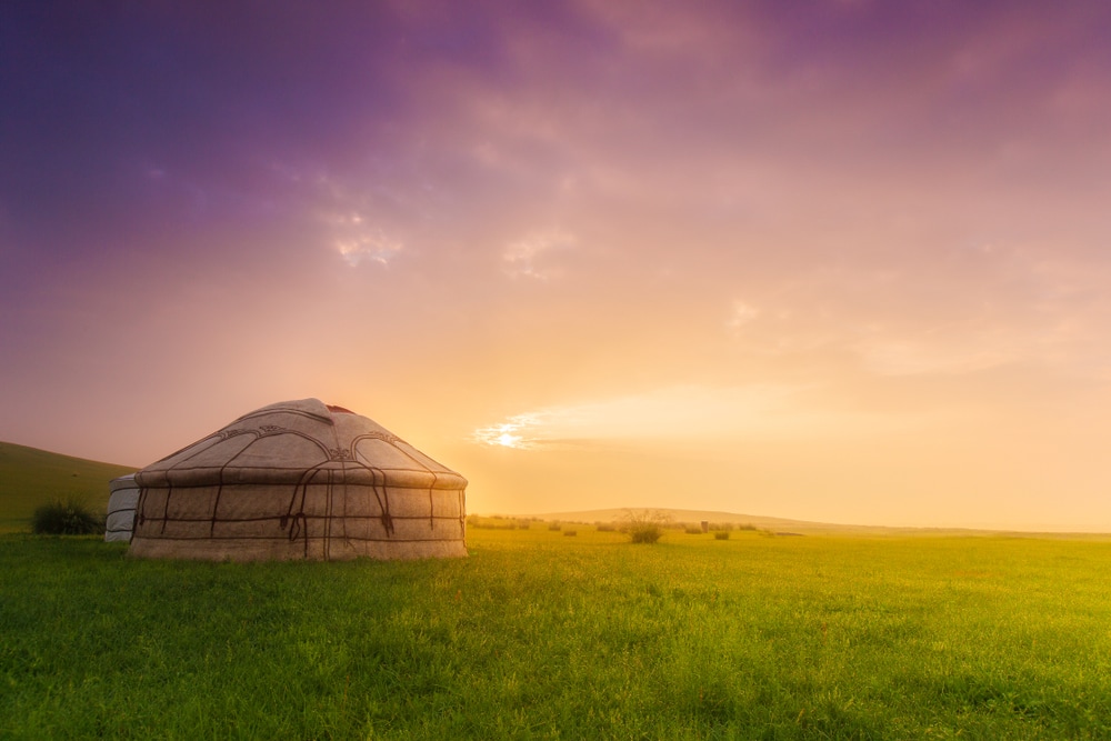 Built shelter in the middle of fields under sunset