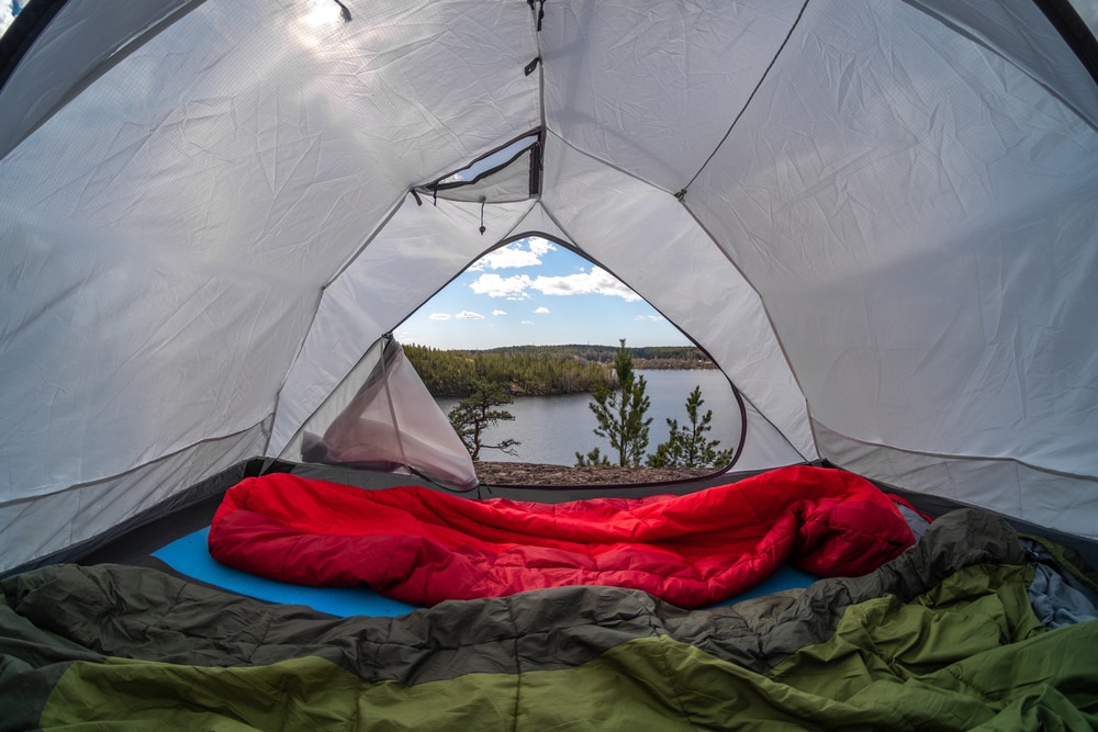 Inside the camping tent with blanket and comforter