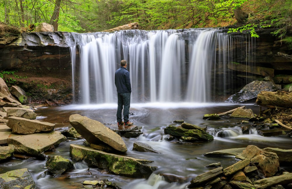 Man standing in one of the falls in Virginia