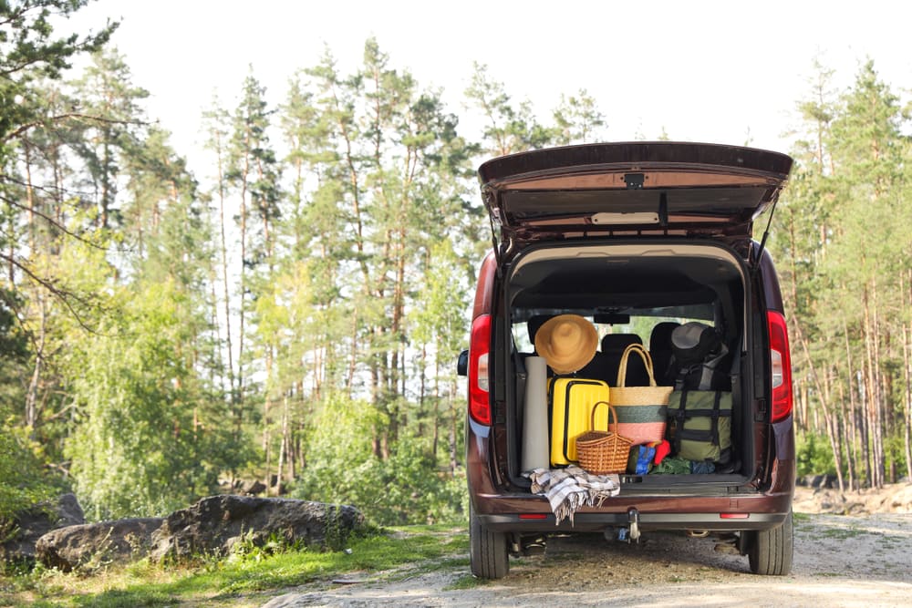 a van with camping equipments on trunk