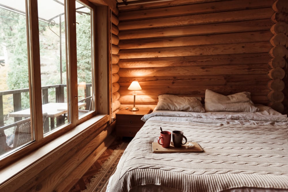 interior of a cabin with a cozy bed. cabin  camping is one of the camping styles where you can enjoy nature even without all the camping gears