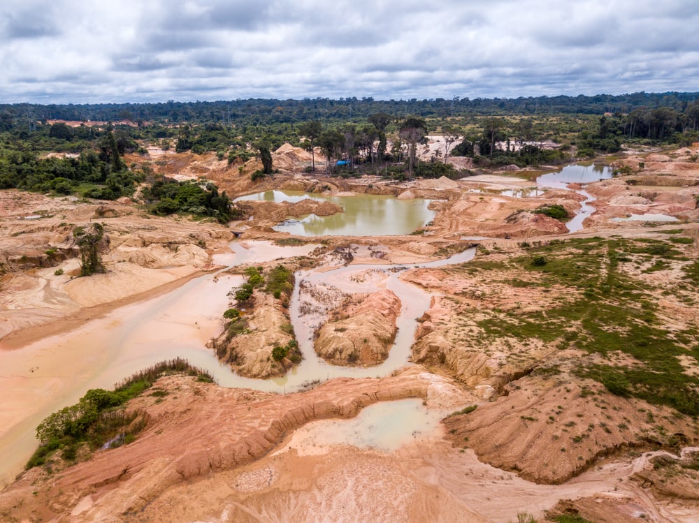 aerial view of deforested area in the Amazon Rainforest caused by illegal mining  and logging