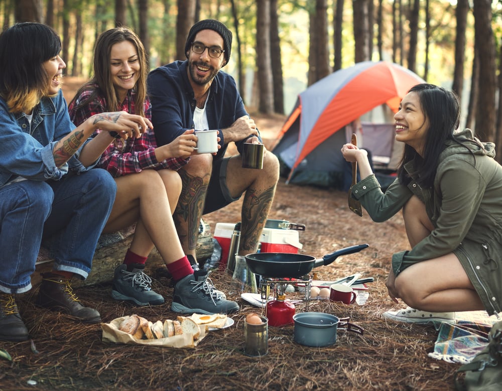 a group of friends laughing on a camp