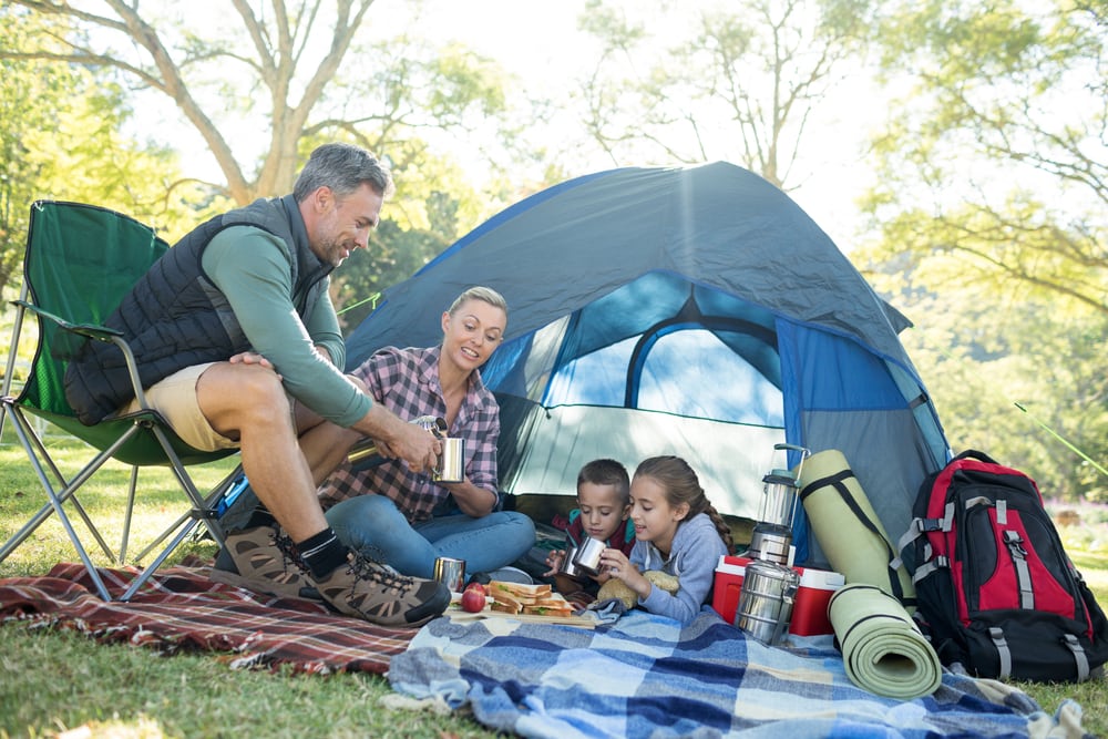 family with kids enjoying a tent camping style