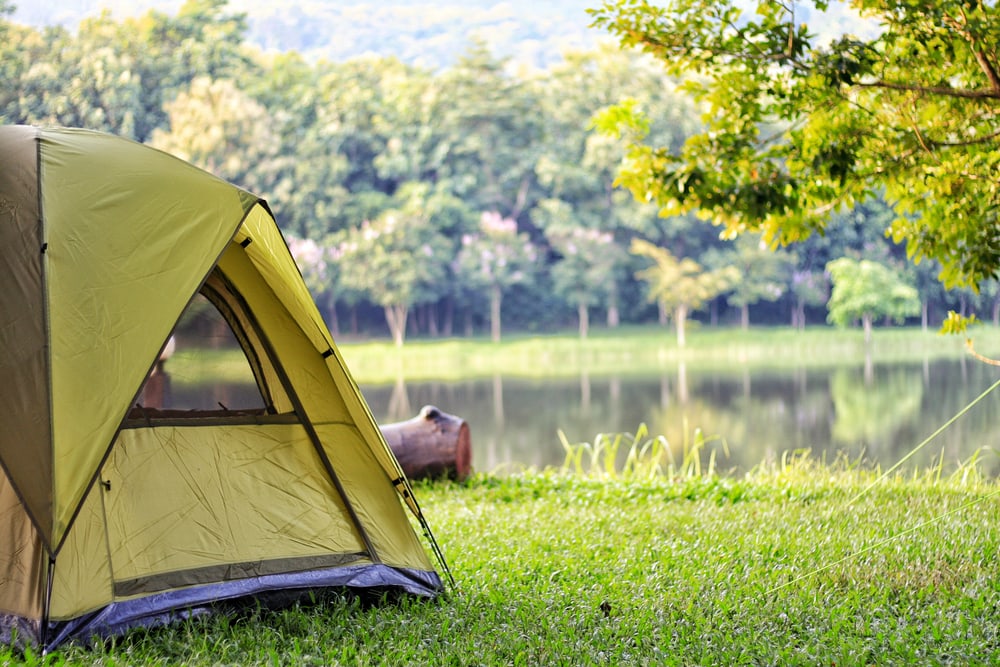 image of a tent a campground near a pond