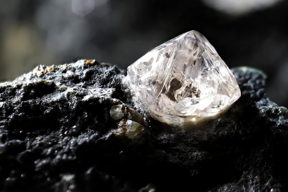 one of the most famous types of gems, diamond. An uncut and natural diamond nestled on a kimberlite
