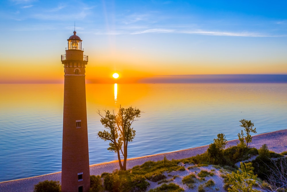 Aerial view of Little Sable Point Lighthouse as the sun sets over Lake Michigan