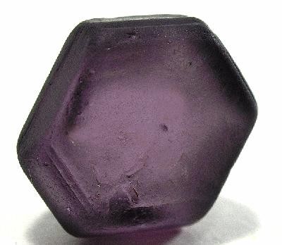 image of taaffeite stone form Sri Lanka showing its purple hues on a white background