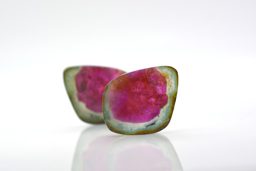 watermelon tourmalines pink and green polished and shiny on white background