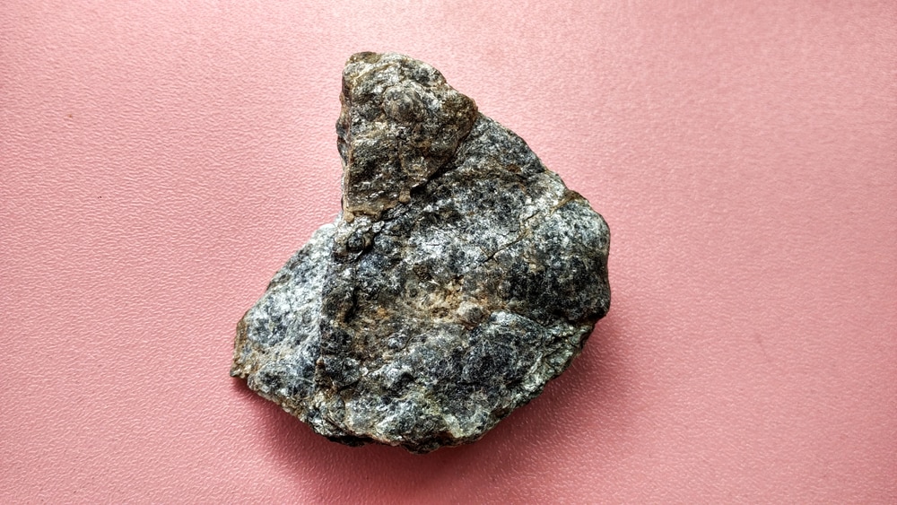 Schist rock laying on pink table