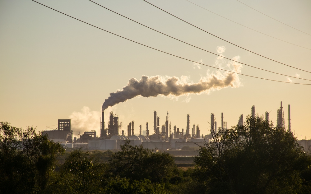 large refineries emitting polluting carbon and cancer causing smoke stacks climate change
