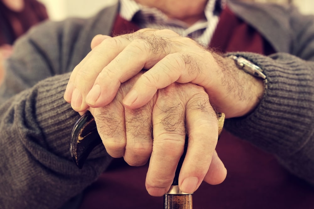 close up image of the hands of an old man
