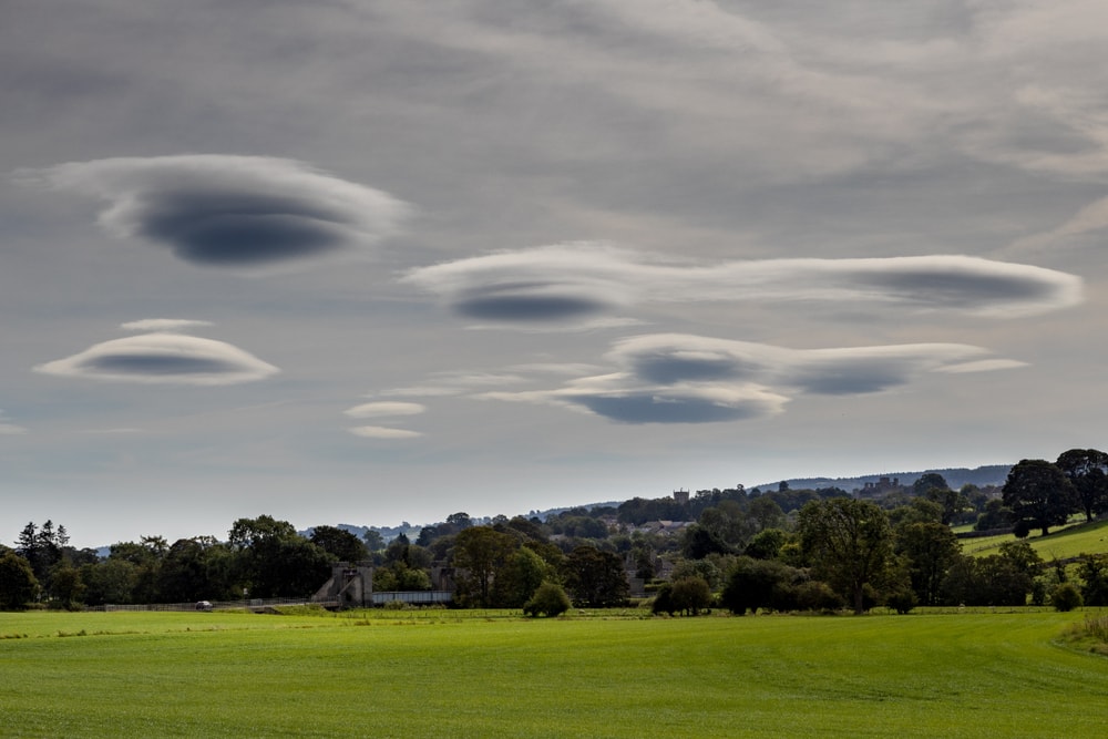 Group of Lenticular clouds seen above the fields