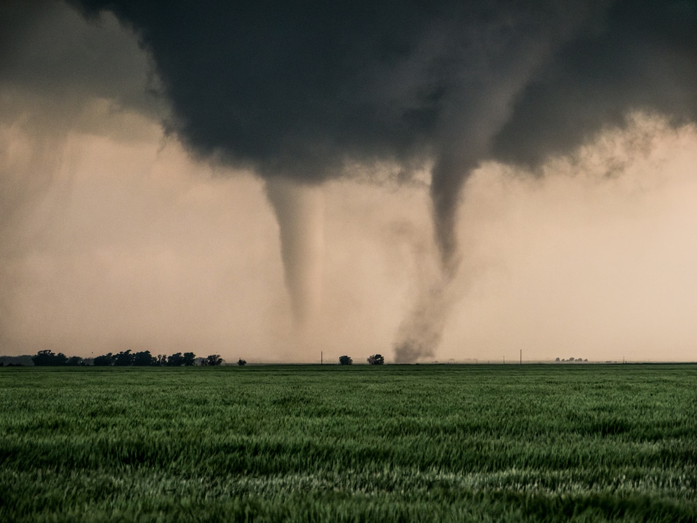 image of  two tornadoes hitting a grass field                                             vn in Oklahoma