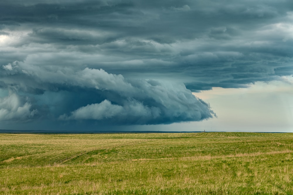 image of a tornado starting to form in a grassy field in Great Plains