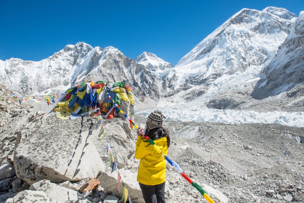 a woman trekker paying respect in the memorial on the mount Everest base camp