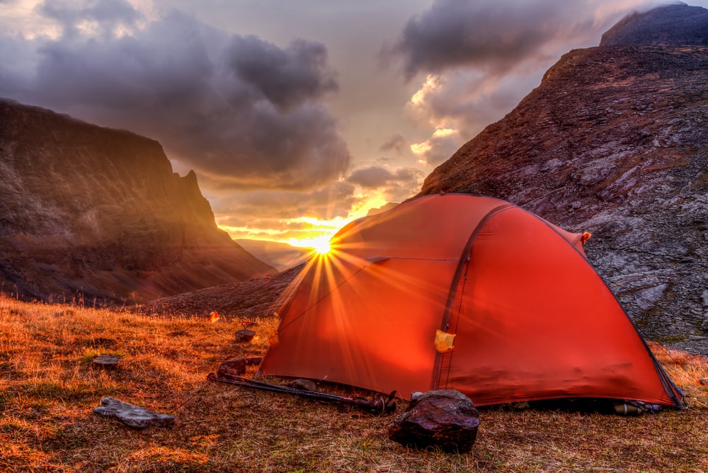image of a dome tent in the mountain during sunset