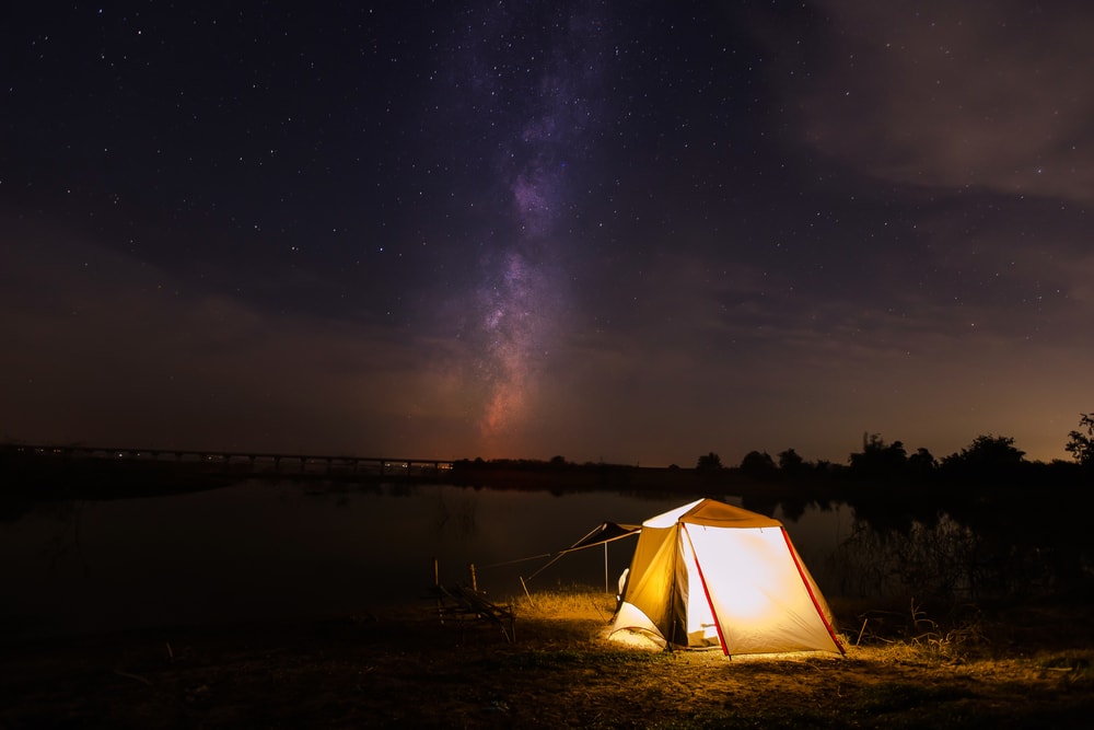 a tent opened under a starry sky 