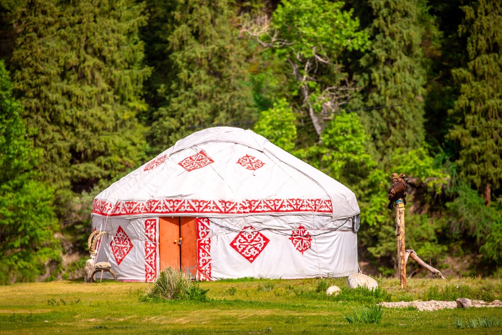 Red and white yurt in the field